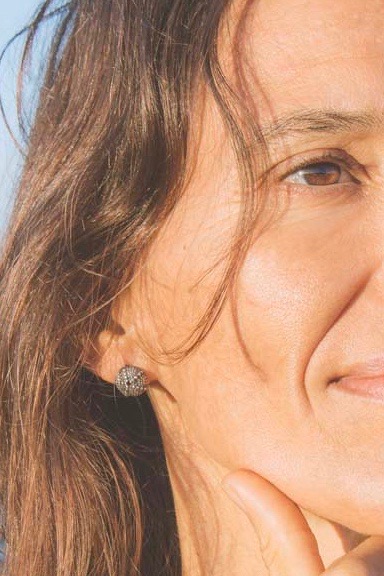 Face of a woman wearing sea urchin oxidised silver earstud